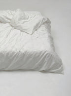Bloom duvet cover from the foot of the bed, turned back to show the weight of the cotton