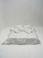 Picarde Form duvet cover in white, styled loosely to show the drape of the cotton